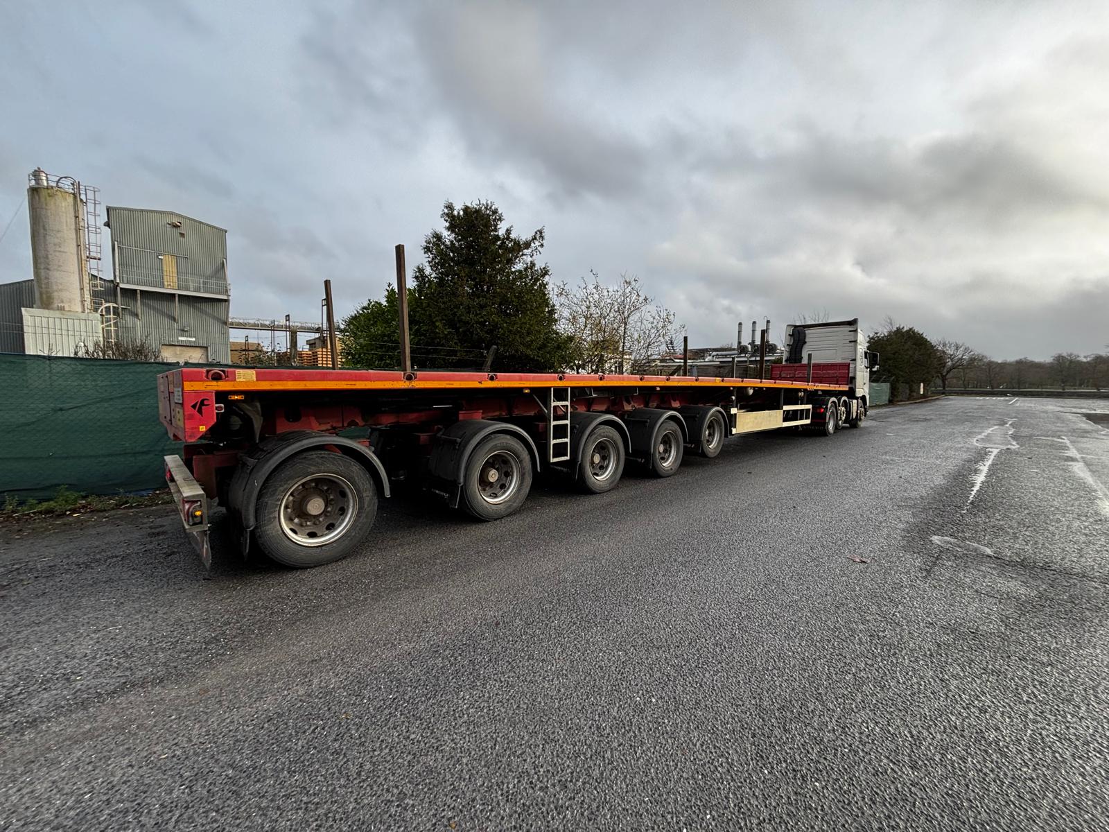 White truck and curtainsider trailer